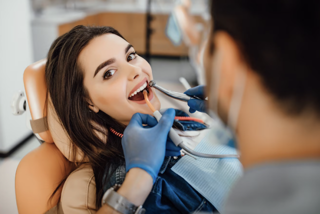 woman sat in dental chair with dentist