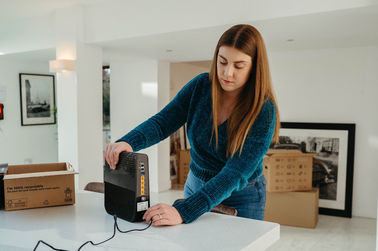 woman plugging in broadband router