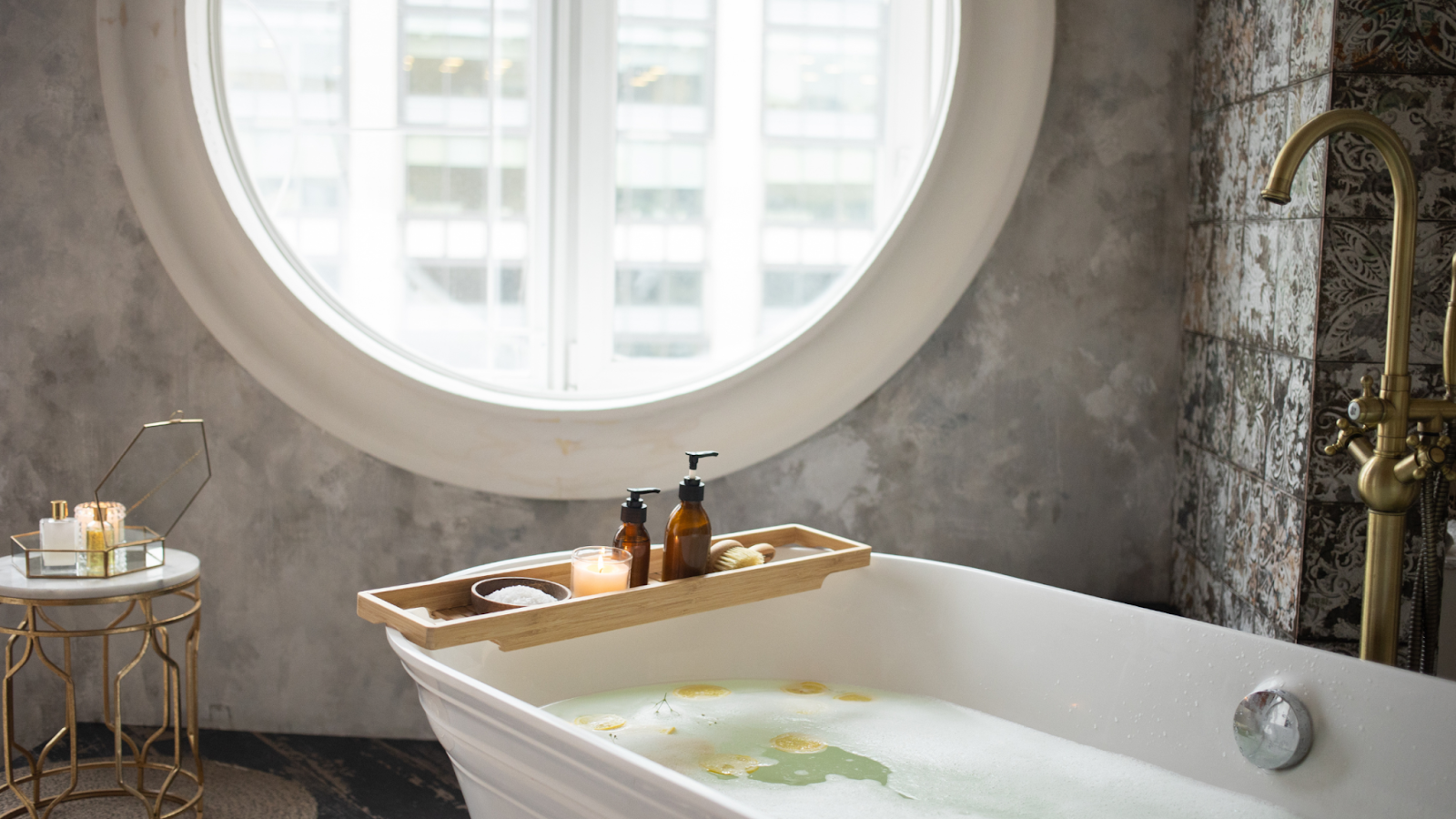 A stunning bathroom with grey, black, and white colors.