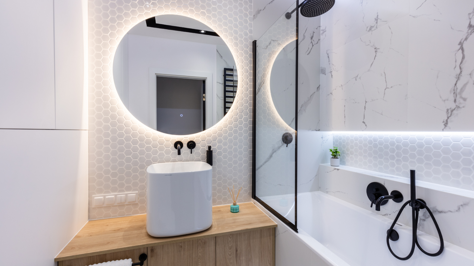 A small bathroom with additional lighting to make it look larger.