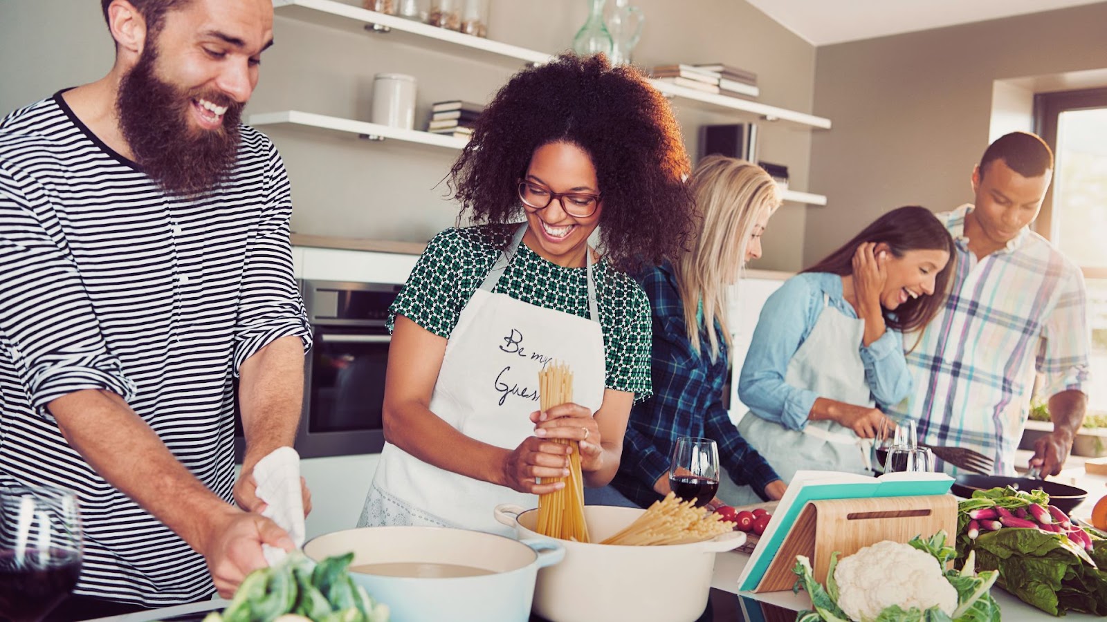 A group of friends and family cooking together.