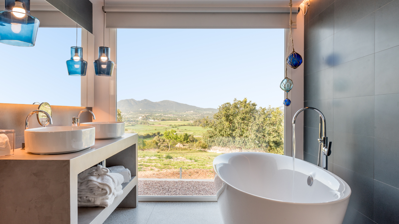 A bathroom with large window and trending finishes.