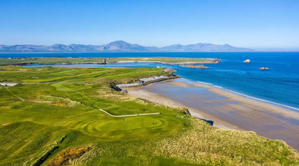 aerial view of tralee golf club with sea and mountains