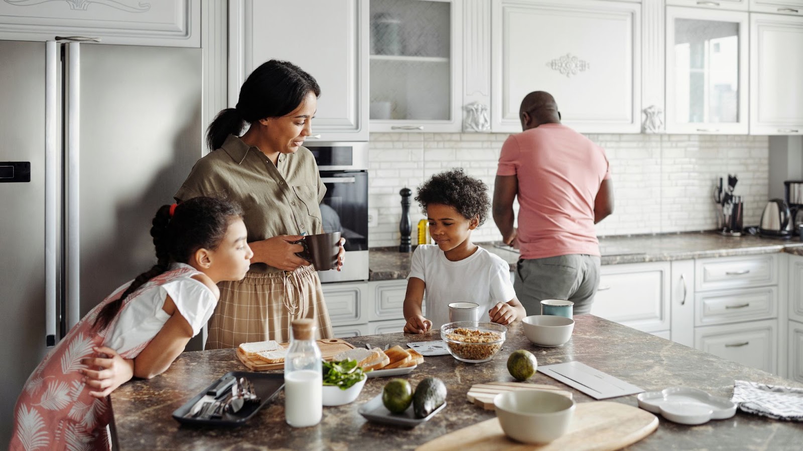 A family busy using the kitchen.