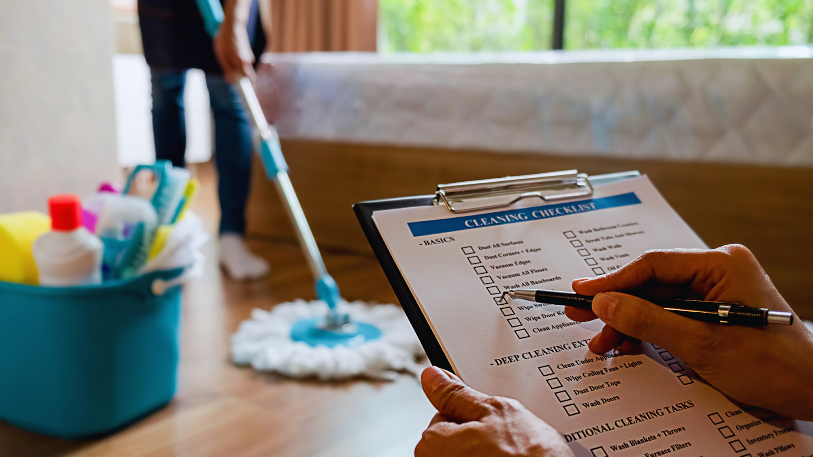 A person completing a cleaning checklist. 