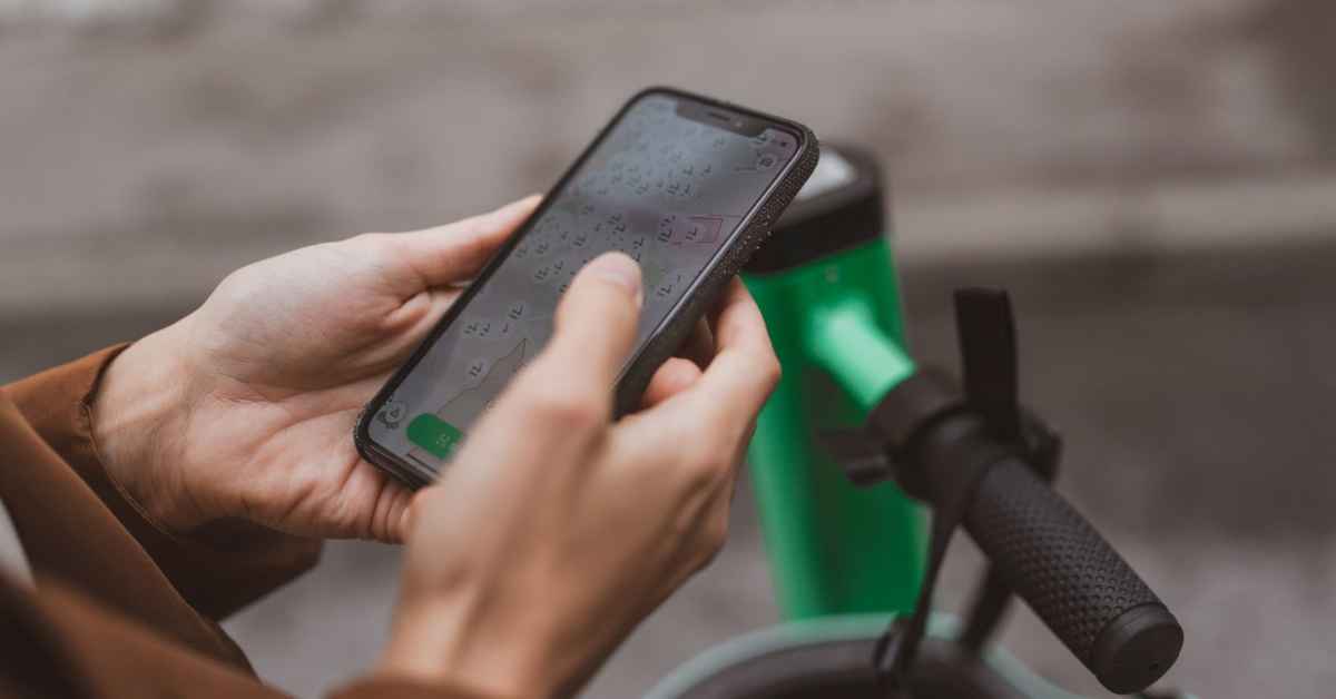 Business person unlocking a Bolt scooter in the Bolt app.