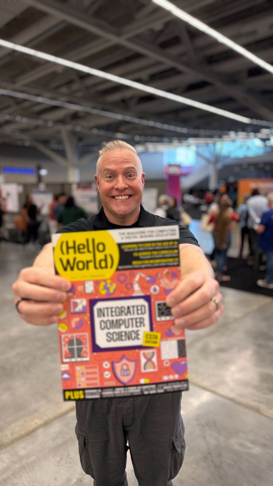 Rick Ballew CS & Engineering teacher in Minnesota, USA smiling holding a physical copy of Hello World issue 27