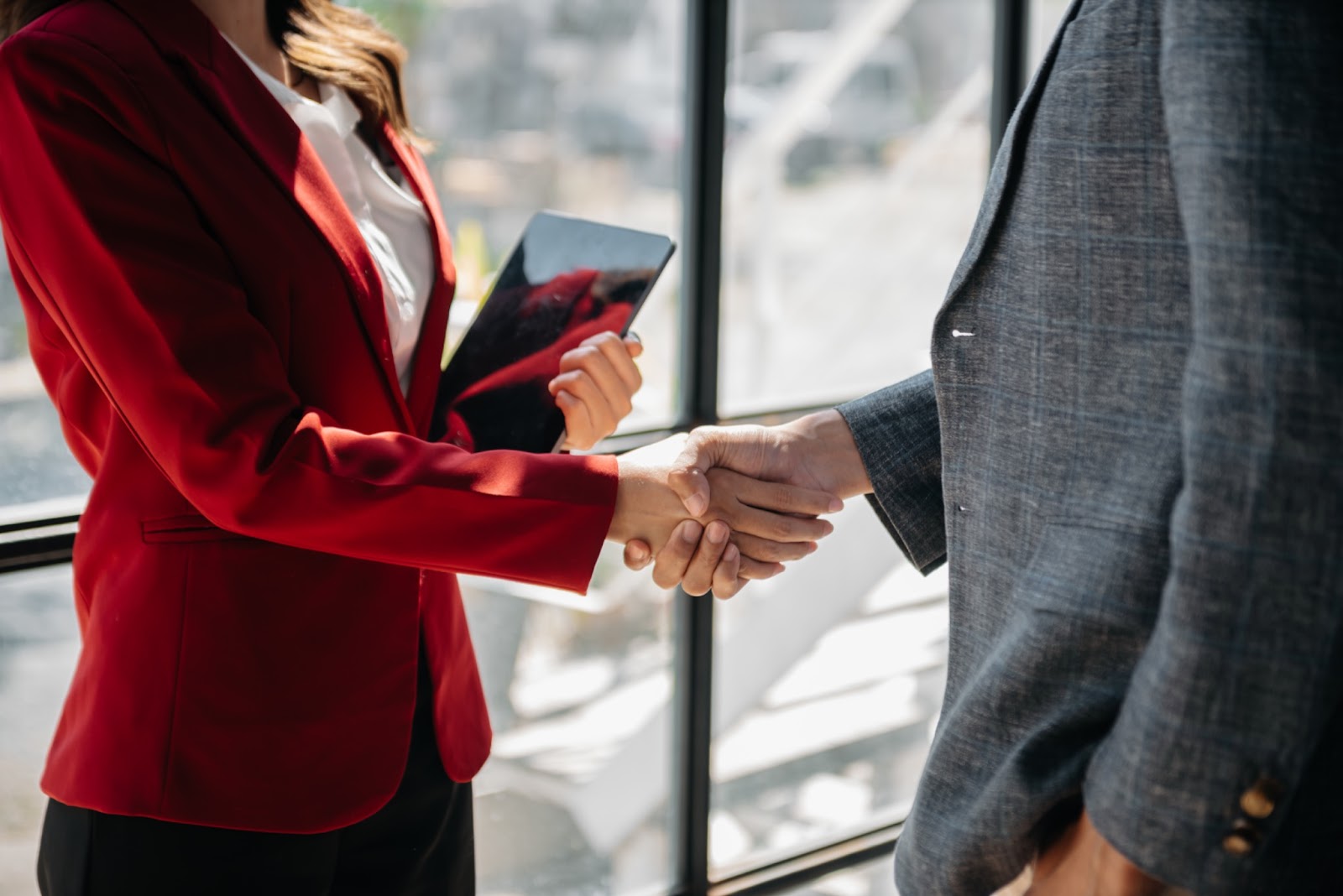 "Two business professionals shaking hands, symbolizing partnership and collaboration at the enterprise level."
