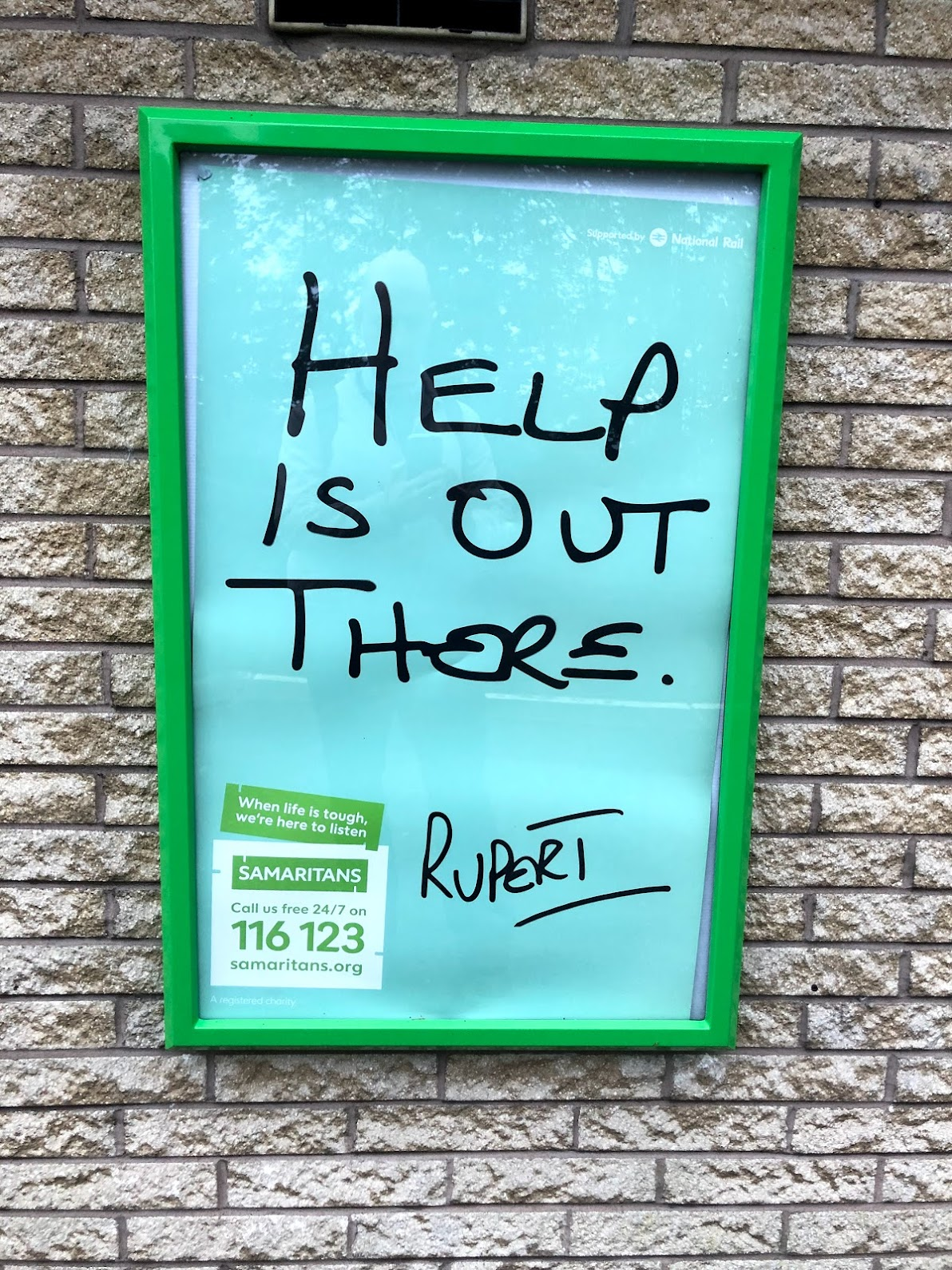A poster for the Samaritans, found at my local train station. It reads "help is out there. And is hand signed 'Rupert'
